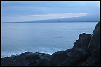 Lava rock shore and Mauna Loa shield profile from South Point. Big Island, Hawaii, USA