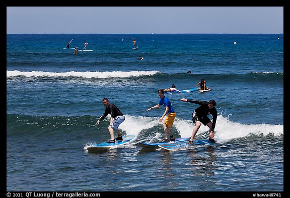 Surfing students ride the same wave. Lahaina, Maui, Hawaii, USA