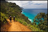 Hikers on Kalalau trail, Na Pali coast. Kauai island, Hawaii, USA