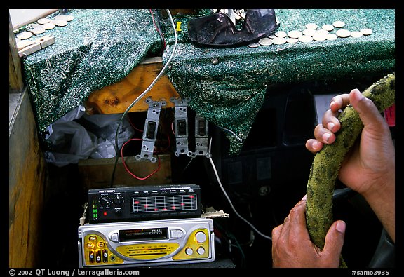 Hands of Aiga bus driver and sound system. Pago Pago, Tutuila, American Samoa (color)