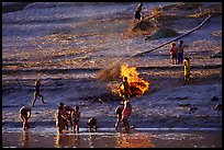 Children bathe in the river and dry out near a fire in a small hamlet. Mekong river, Laos ( color)