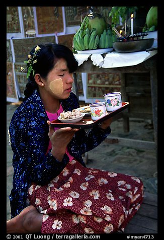Burmese woman offering food. Bagan, Myanmar