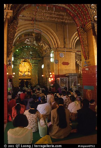 Woman praying at the venerated Mahamuni image. Mandalay, Myanmar