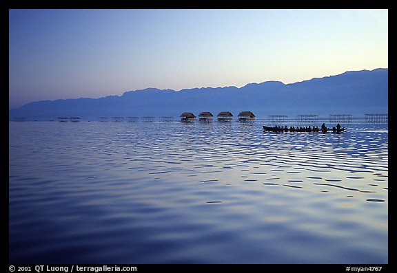 Long boat,  stilts huts, and mountains, sunrise. Inle Lake, Myanmar