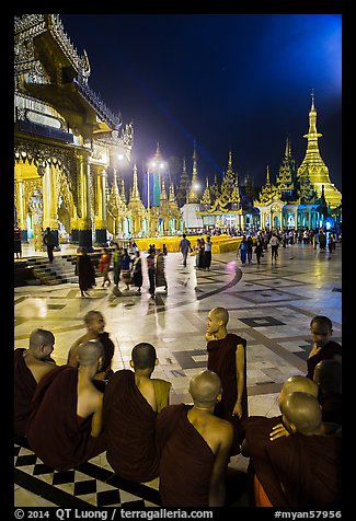 Monks, Terrace and Naungdawgyi (Elder Brother) Pagoda at night, Shwedagon Pagoda. Yangon, Myanmar