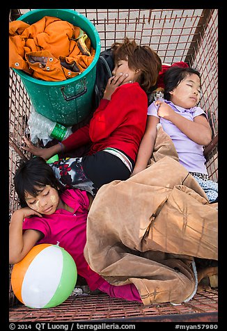 Children sleeping in street cleaning cart. Yangon, Myanmar (color)