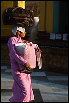 Nun carrying lots of luggage, Shwedagon Pagoda. Yangon, Myanmar