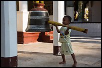 Child ringing bell, Shwedagon Pagoda. Yangon, Myanmar