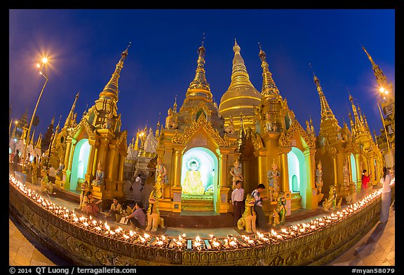 Oil lamps and stupas at dusk, Shwedagon Pagoda. Yangon, Myanmar (color)