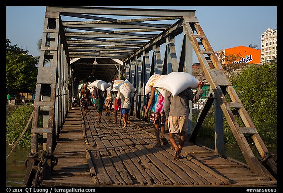 Workers unload bags of rice, Sinodan pier. Yangon, Myanmar (color)