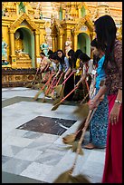 Women sweeping platform, Shwedagon Pagoda. Yangon, Myanmar