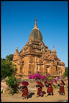 Four novices walk next to temple. Bagan, Myanmar