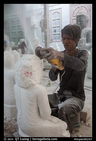 Man carving marble buddha statue with grinder. Mandalay, Myanmar (color)