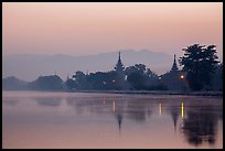 Pagodas reflected in moat at dawn, Mandalay Fort. Mandalay, Myanmar ( color)