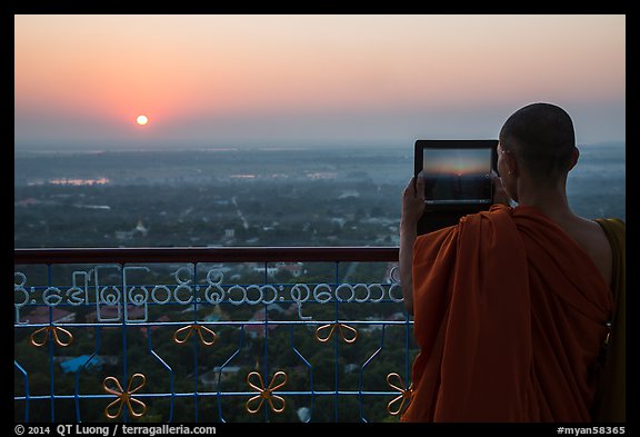 Monk taking picture of sunset from Sagaing Hill. Myanmar (color)