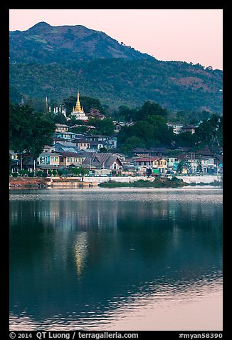 Hill and town reflected in Pone Tanoke Lake at dawn. Pindaya, Myanmar (color)