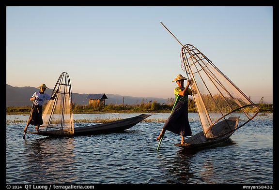 Intha fishermen row with leg and hold conical baskets. Inle Lake, Myanmar (color)