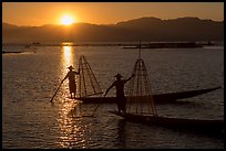 Intha fishermen on long flat-bottomed boats at sunset. Inle Lake, Myanmar ( color)