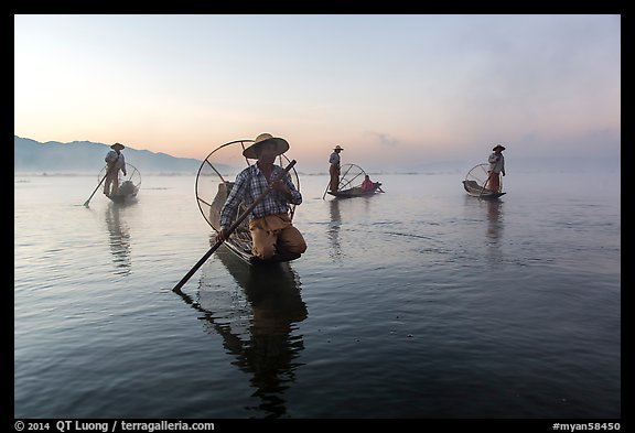 Group of Intha fishermen at dawn with surface mist. Inle Lake, Myanmar (color)
