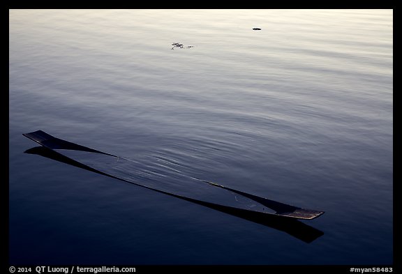 Sunken canoe and rippled water. Inle Lake, Myanmar (color)