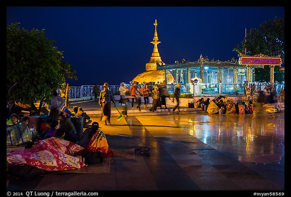 Pilgrims wake up after sleeping on plaza behind Golden Rock. Kyaiktiyo, Myanmar (color)