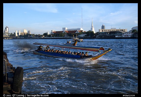 Crowded long tail taxi boat on Chao Phraya river. Bangkok, Thailand