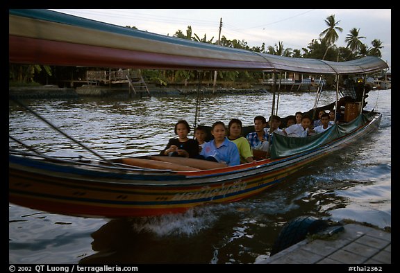 Evening commute, long tail taxi boat on canal. Bangkok, Thailand