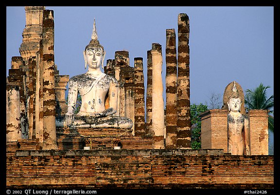 Columns and Buddha statue, Wat Mahathat. Sukothai, Thailand (color)