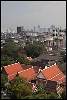 Temple rooftop and modern skyline. Bangkok, Thailand