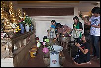 Worshippers with lotus inside Wat Saket. Bangkok, Thailand (color)