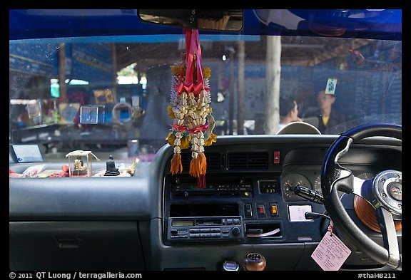 Bus dashboard with religious items. Thailand