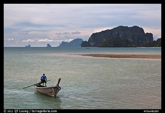 Man driving long tail boat, Ao Nammao. Krabi Province, Thailand