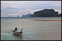 Man driving long tail boat, Ao Nammao. Krabi Province, Thailand (color)
