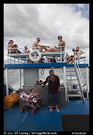 Local woman and tourists on boat, Adaman Sea. Krabi Province, Thailand (color)