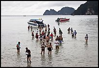 Asian tourists wading in water, Ko Phi Phi. Krabi Province, Thailand (color)
