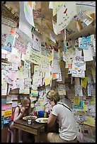 Women eating at Pad Thai restaurant decorated with customer notes, Ko Phi-Phi Don. Krabi Province, Thailand (color)
