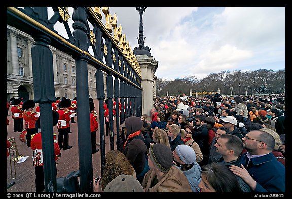 Crowds at the grids in front of Buckingham Palace watching the changing of the guard. London, England, United Kingdom (color)