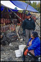 Inupiaq Eskimo man and woman next to fish hung for drying, Ambler. North Western Alaska, USA ( color)