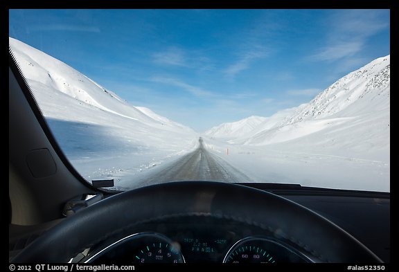 Road in wintry landscape seen from dashboard indicating -32F temperature. Alaska, USA