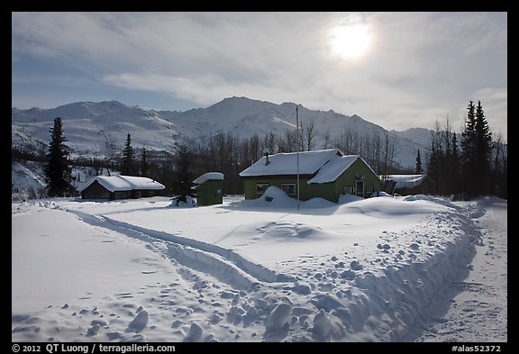 Backlit view of snow-covered village. Wiseman, Alaska, USA