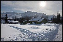 Backlit view of snow-covered village. Wiseman, Alaska, USA