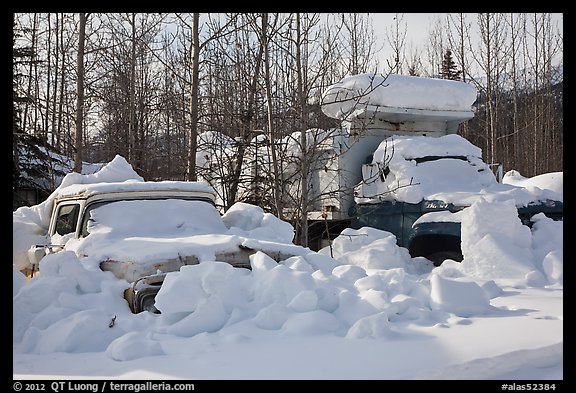 Trucks covered with piles of snow. Wiseman, Alaska, USA