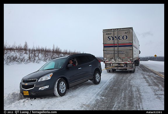 Commercial truck towing car, Dalton Highway. Alaska, USA