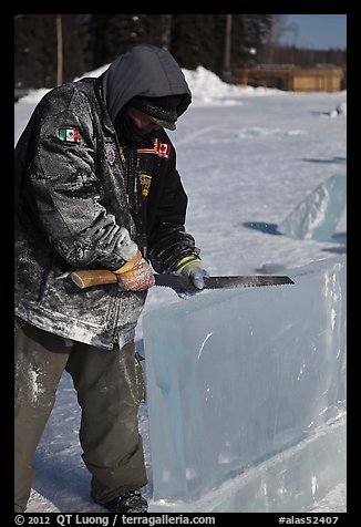 Ice artist carving with saw. Fairbanks, Alaska, USA