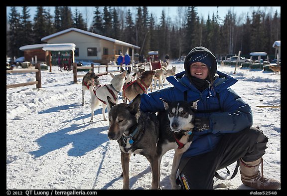 Woman dog musher posing with dog team. Chena Hot Springs, Alaska, USA (color)
