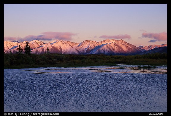 Lake with water ripples and mountains at sunset. Alaska, USA