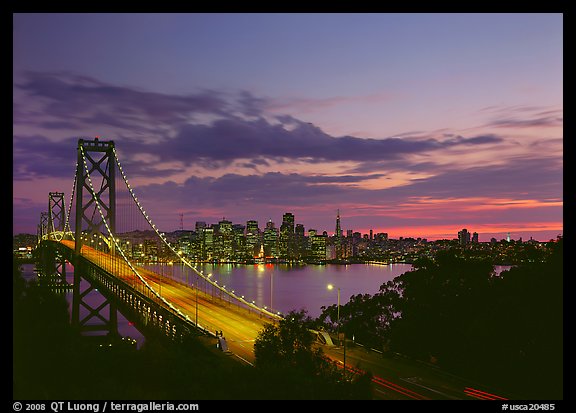 Bay Bridge and city skyline with lights at sunset. California, USA (color)
