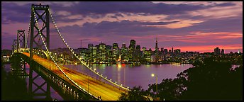 San Francisco cityscape and Bay Bridge at sunset. San Francisco, California, USA (Panoramic color)