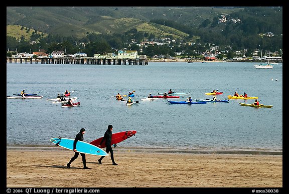 Surfers and sea kayakers, Pillar point harbor. Half Moon Bay, California, USA