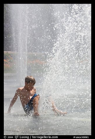 Boy playing in water,  Cesar de Chavez Park. San Jose, California, USA (color)